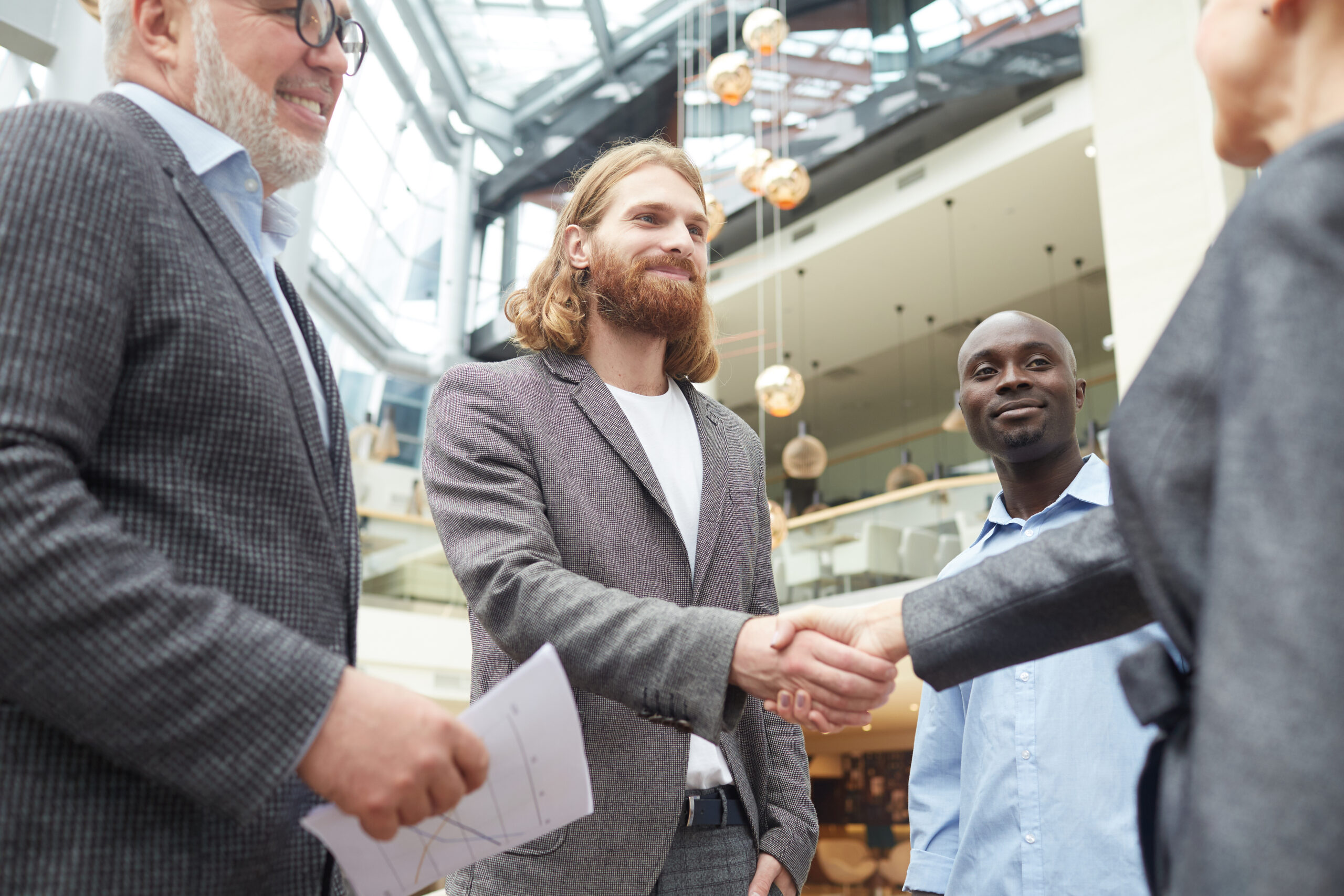 Business professionals shaking hands as a sign of effective sales outreach.